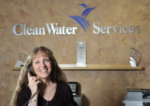 A Clean Water Services employee helps a community member file a permit at the Permits counter in Hillsboro