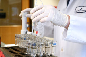 A Clean water services employee adds material into test tubes in the lab onsite.