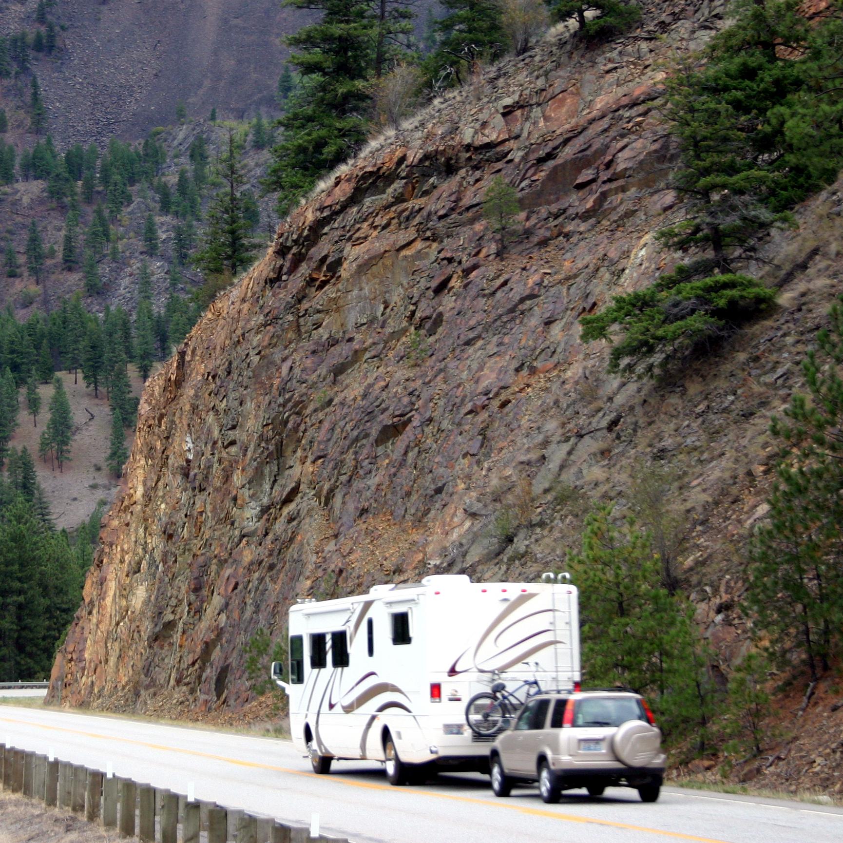 A motor home, RV, pulls a car behind it while driving around a mountain on the way to a campsite. A motor home, RV, pulls a car behind it while driving around a mountain on the way to a campsite. 177401185 Stock, Drive, Holiday, Tripping, Loan, Hobbies, Retirement, Currency, Fun, Journey, Sport, Vacations, Camping, Montana, Oregon, USA, Summer, Road, Car, RVing, mounatin, Transportation, Fuel and Power Generation, Garden, Home Interior, Land Vehicle, Leisure Activity, Motor Home, Mountain Pass, Outside, Pacific Ocean, Plants, Recreational Pursuit, Residential Building, Sports And Fitness, Sports Utility Vehicle, Stock, The Americas, Travel Locations, Yard, Abies, Automobile, Car, Fir, Plant, Transportation, Tree, Truck, Van, Vehicle