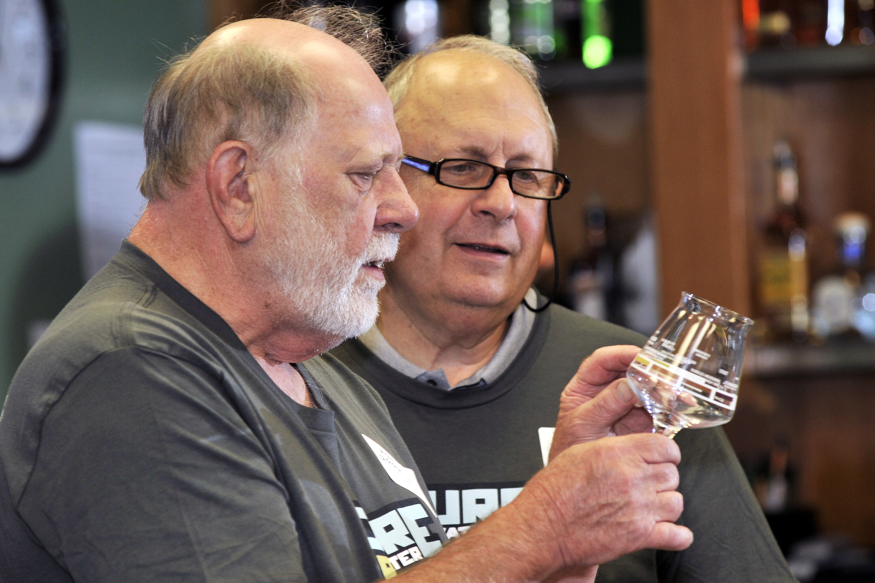 Art Larrance and Bill Gaffi inspect a beer glass